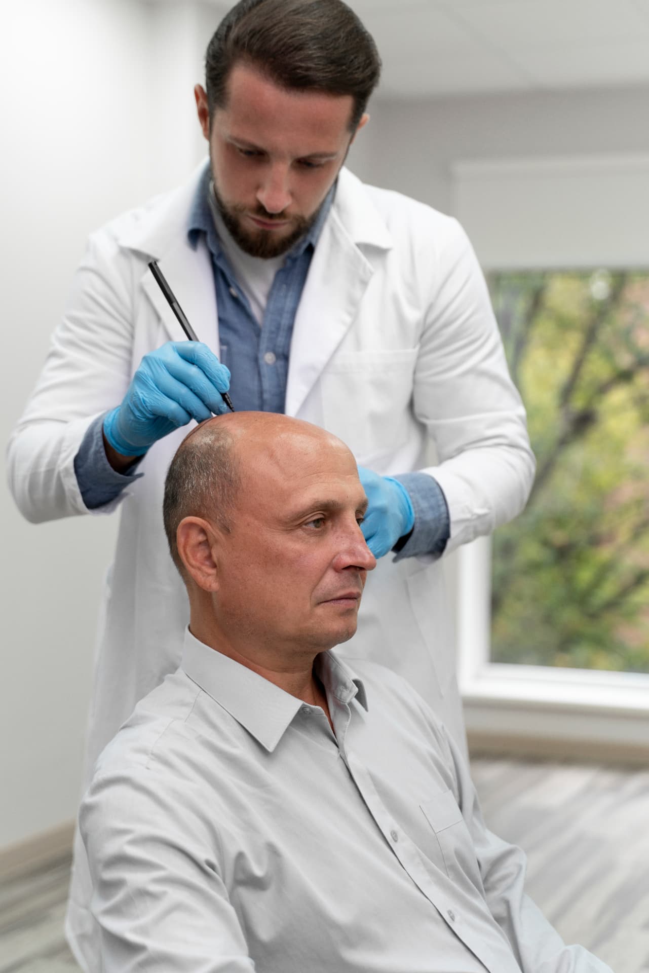 Clinician delivering a gentle scalp treatment in a calm treatment room